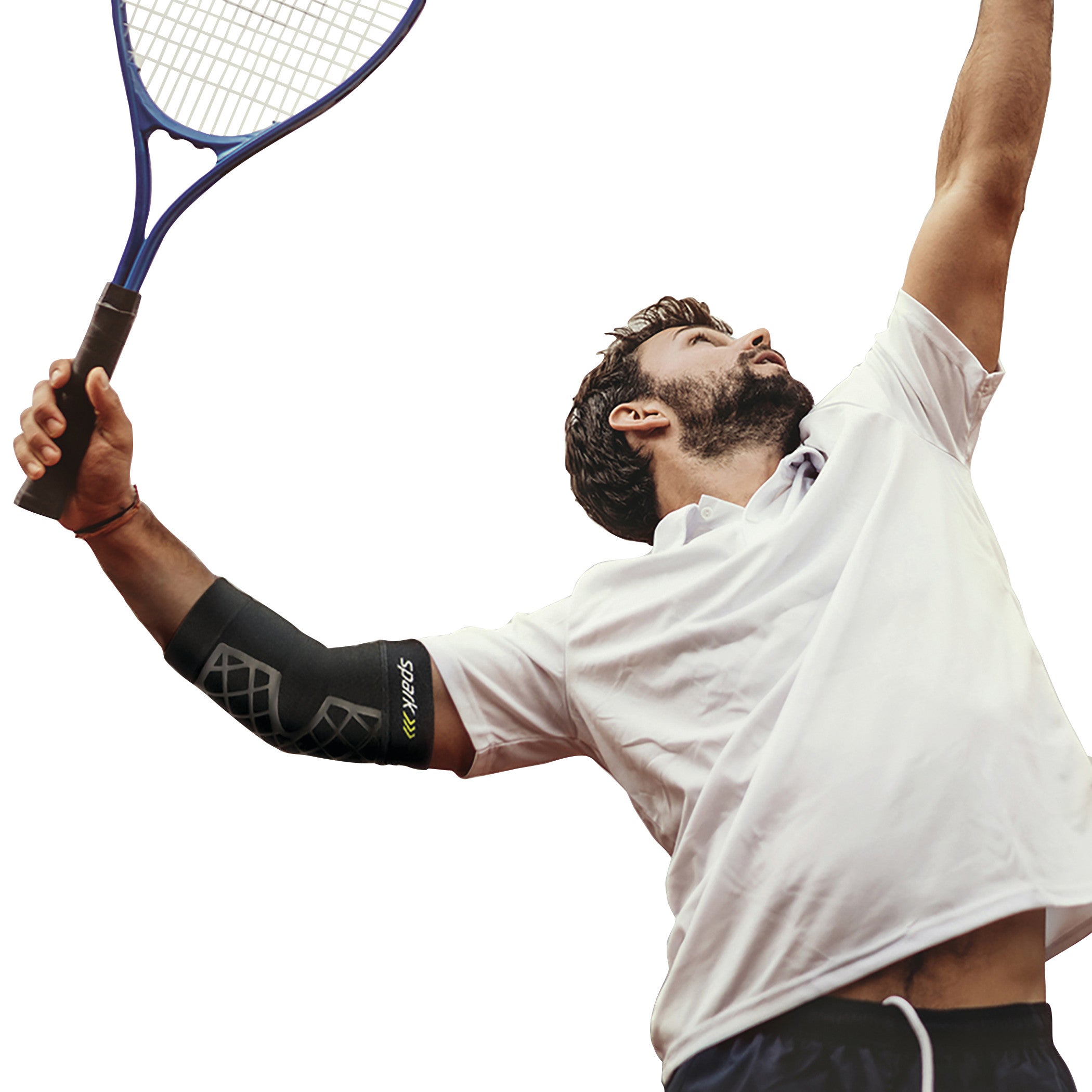 A person in a white shirt is playing tennis, wearing a BrownMed Spark Kinetic Elbow Sleeve on their right arm, mid-serve.