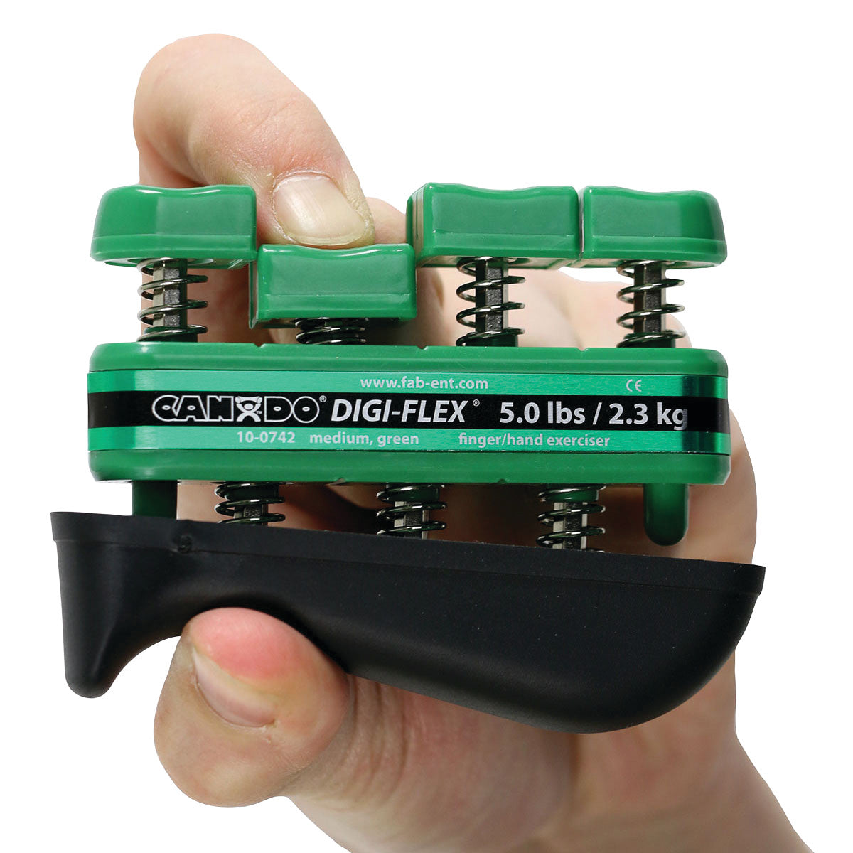 A hand holds a green CanDo Digi-Flex Hand Exerciser labeled 5.0 lbs/2.3 kg, featuring individual finger buttons and springs.