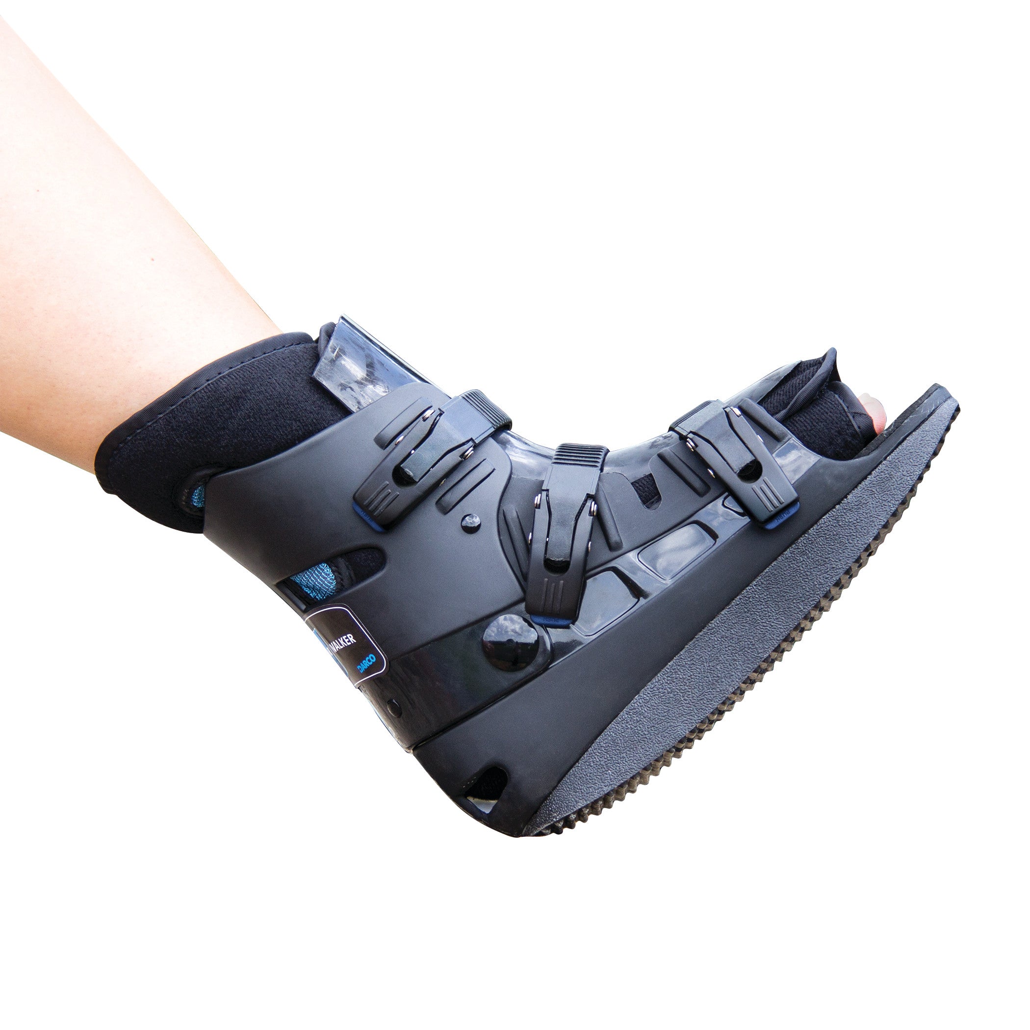 A person's foot in a DARCO Body Armor Low Walker boot, featuring adjustable straps and a solid black sole for support and protection.