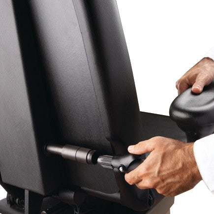 A person adjusts a Midmark Programmable Podiatry Procedure Chair, Model 647, using a lever on the side of the chair's backrest.