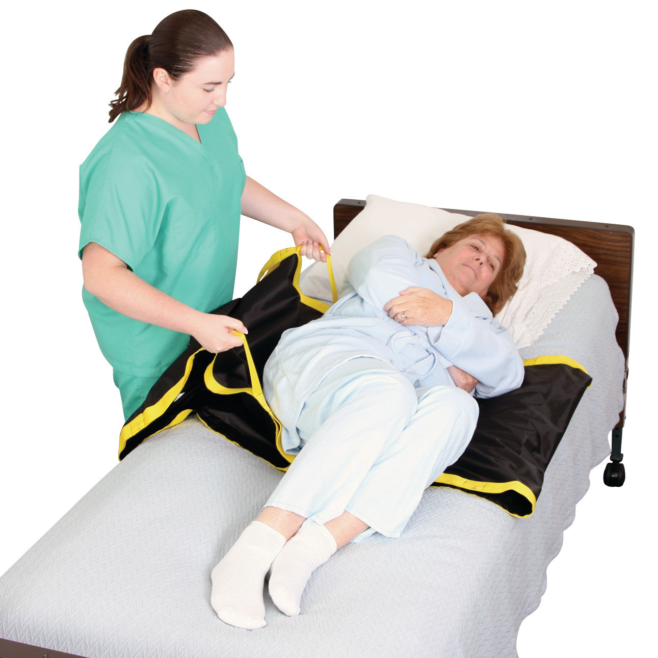 A caregiver assists a person in bed using the AliMed No-Lift TURNER, a black and yellow repositioning aid, to help with turning.
