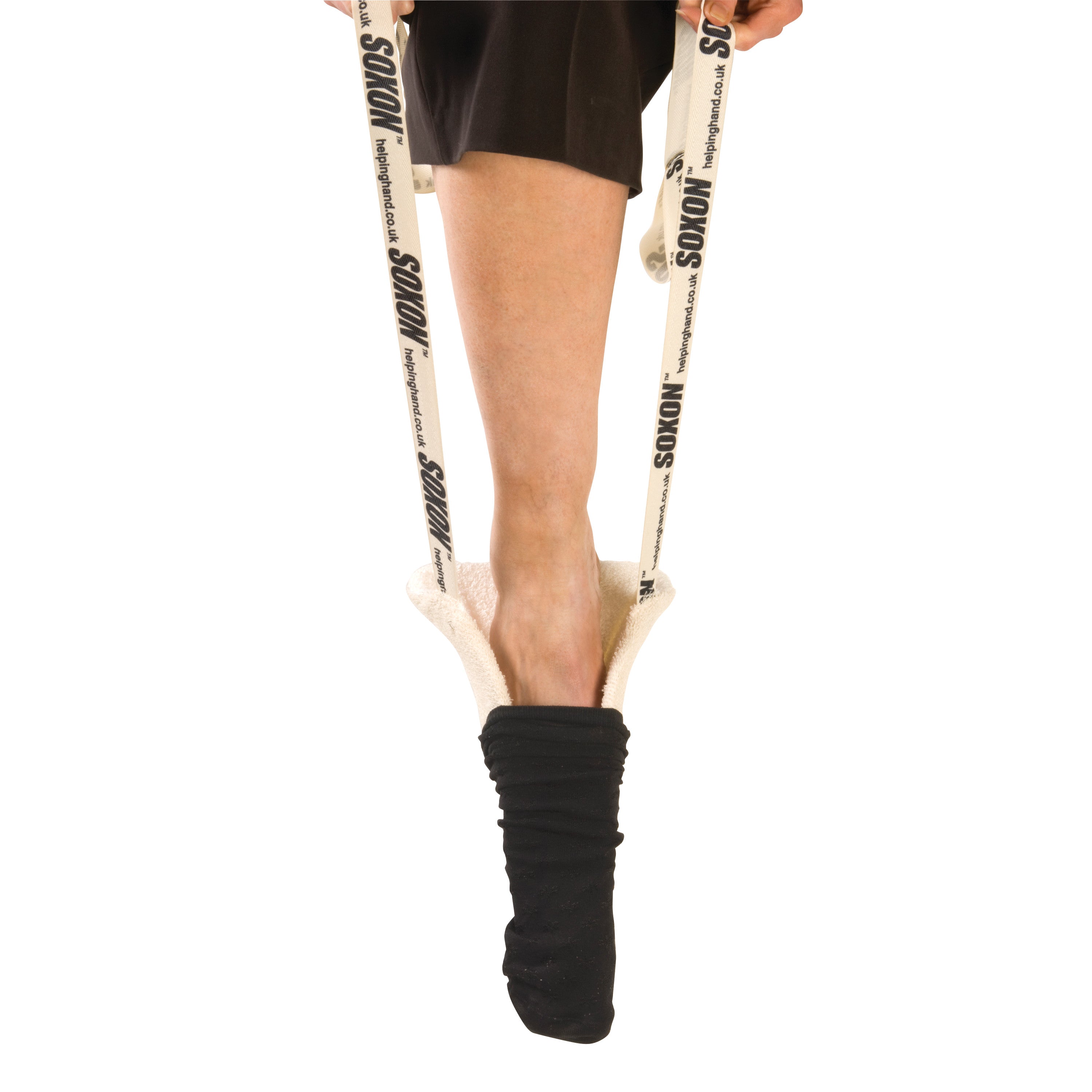 A person's leg uses a Soxon Terrycloth Sock Aid to assist in putting on a black sock. The aid has long straps for easy use.