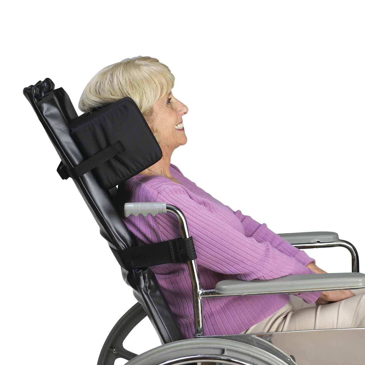 An elderly woman in a wheelchair uses the SkiL-Care Reclining Wheelchair Headrest, providing neck support.