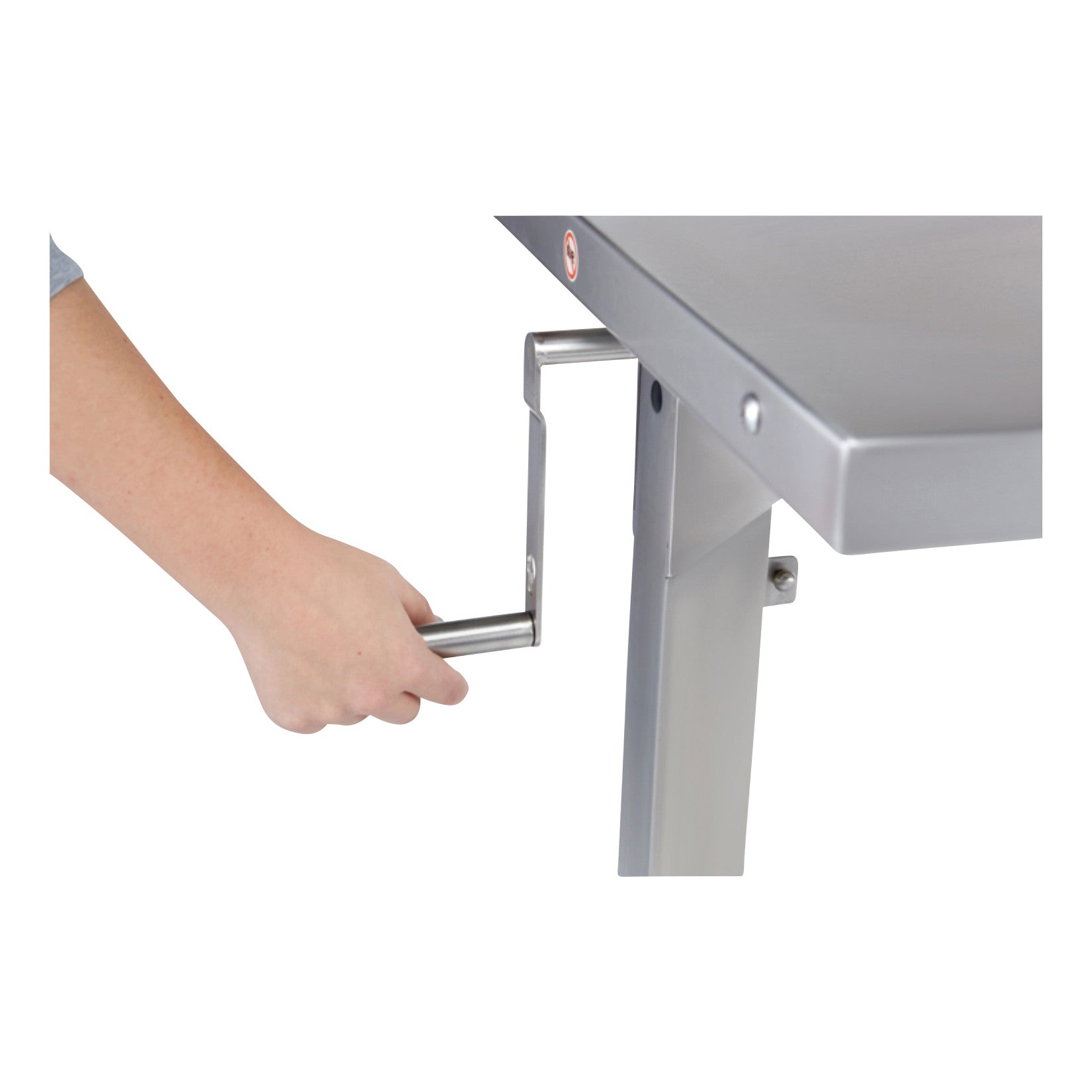 A hand turns the crank handle of a Blickman Georgetown Manual Adjustable Instrument Table, adjusting its height.