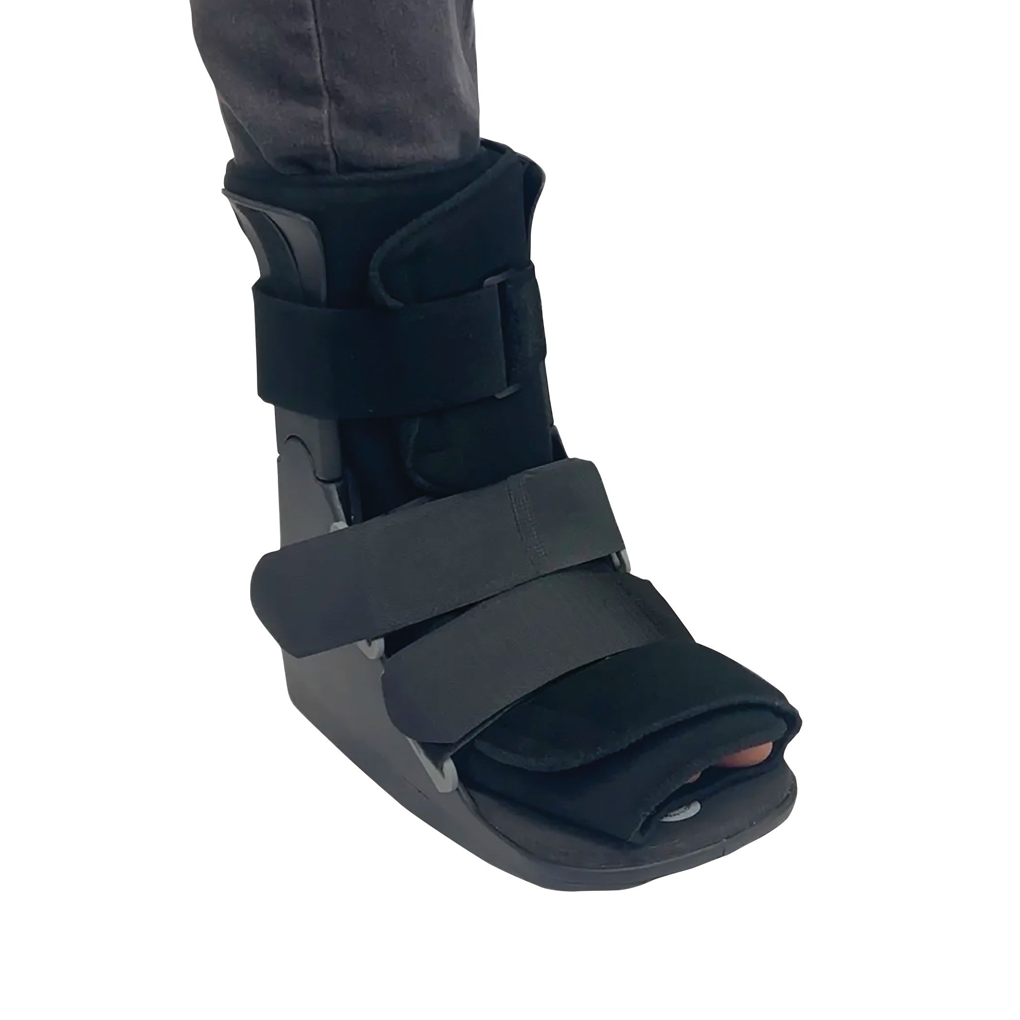 A foot wearing a DARCO FX Pro Low Walker boot with adjustable straps for support and protection.