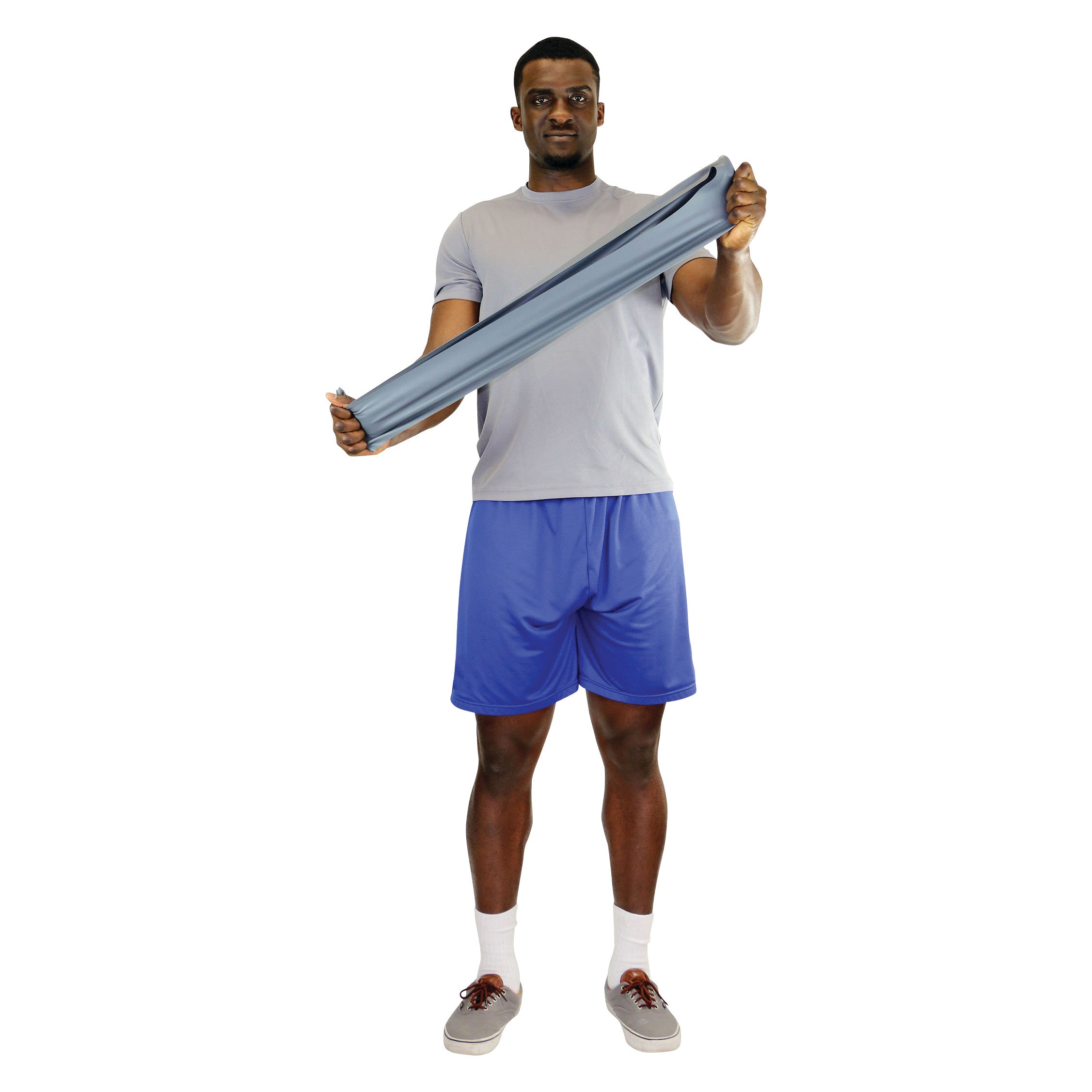 A person stretches a CanDo Sup-R Band Non-Latex Exercise Band, wearing a grey shirt and blue shorts, standing against a white background.