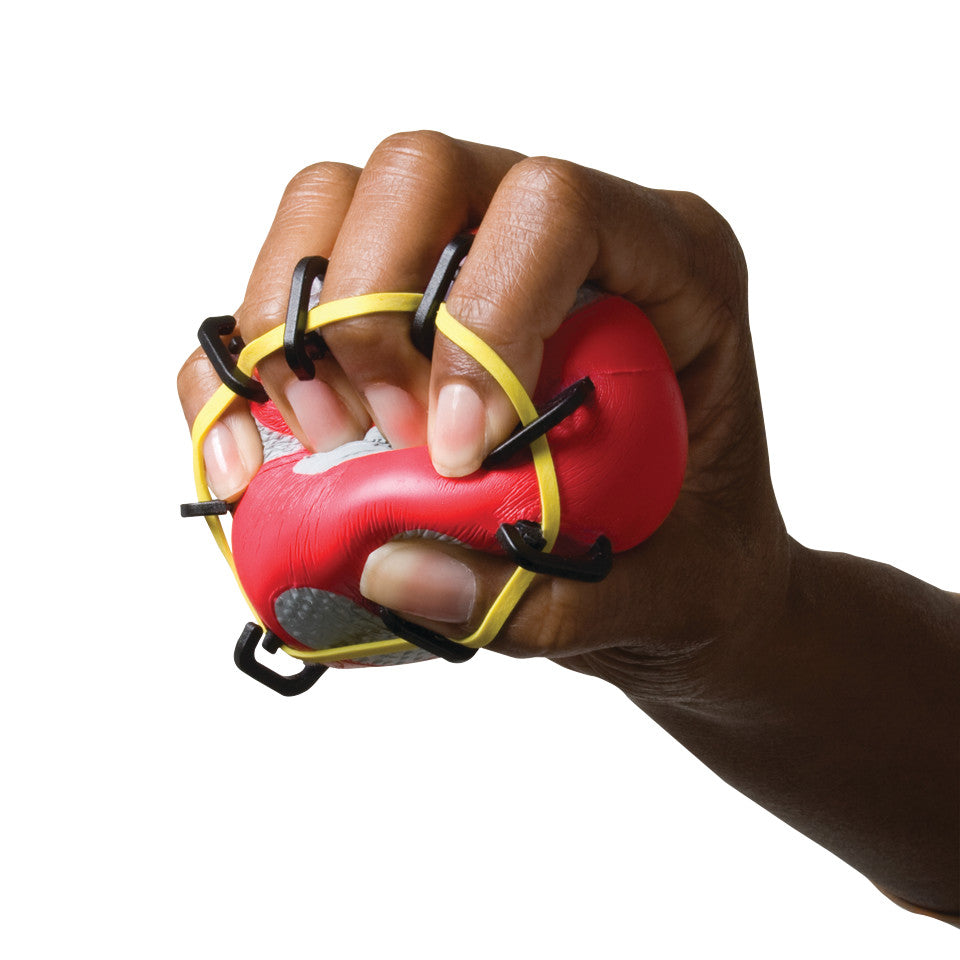 A hand squeezing a red CanDo Digi-Extend n' Squeeze Hand Exerciser with yellow and black bands, focusing on grip and finger extension.