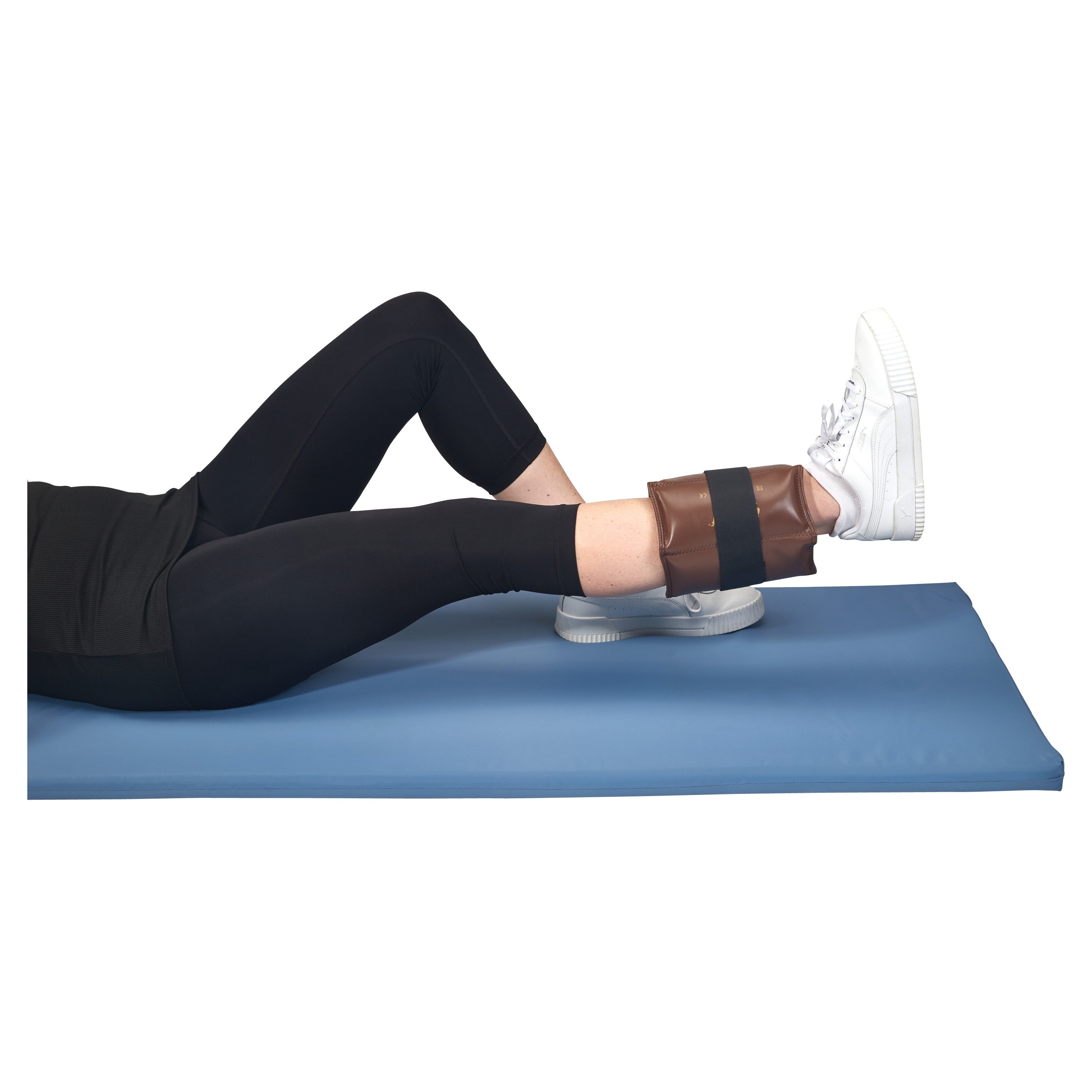 A person lies on a mat with a bent knee, wearing AliMed Color-Coded Cuff Weight on the ankle and white sneakers.