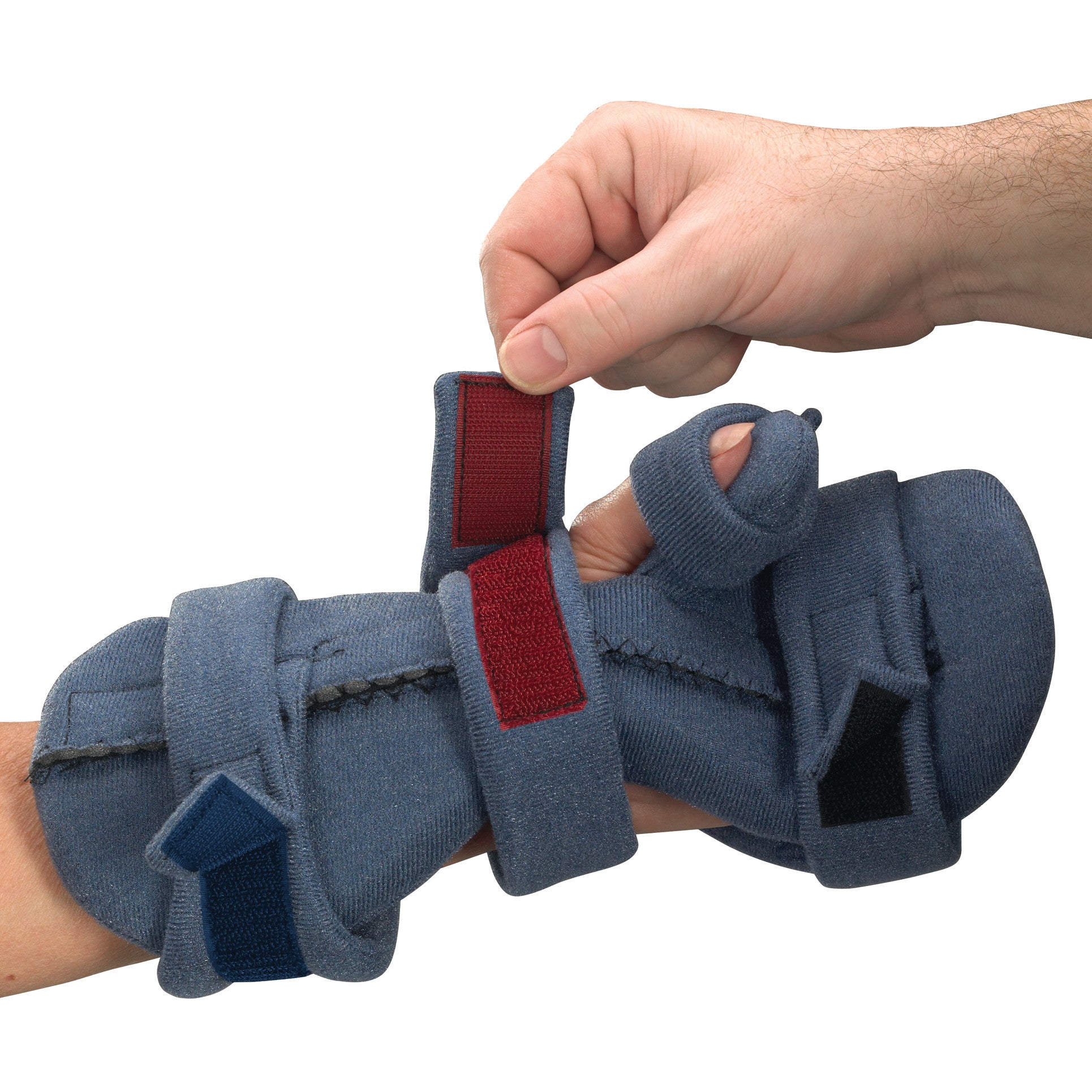 A person adjusts the blue OCSI SoftPro Functional Resting WHFO orthosis on a hand, using its red straps for support.