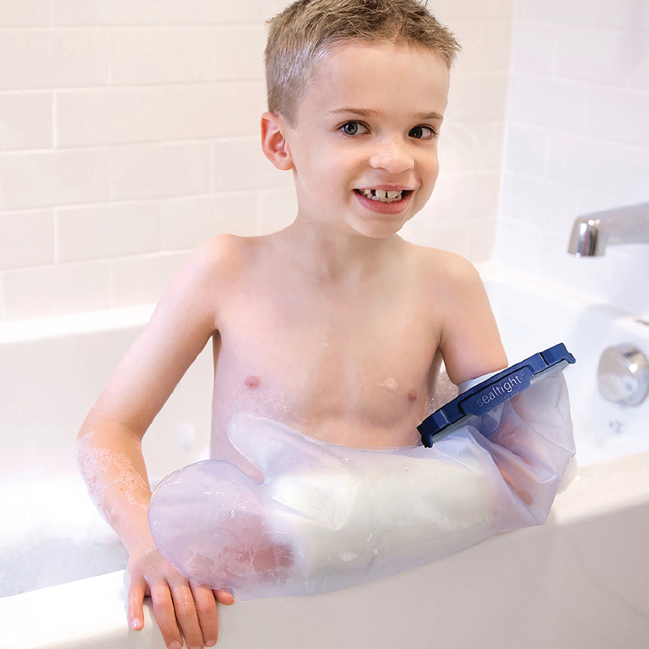 A child bathes using the Brownmed SEAL-TIGHT Infinity Cast Protector on their arm, keeping it dry and protected.