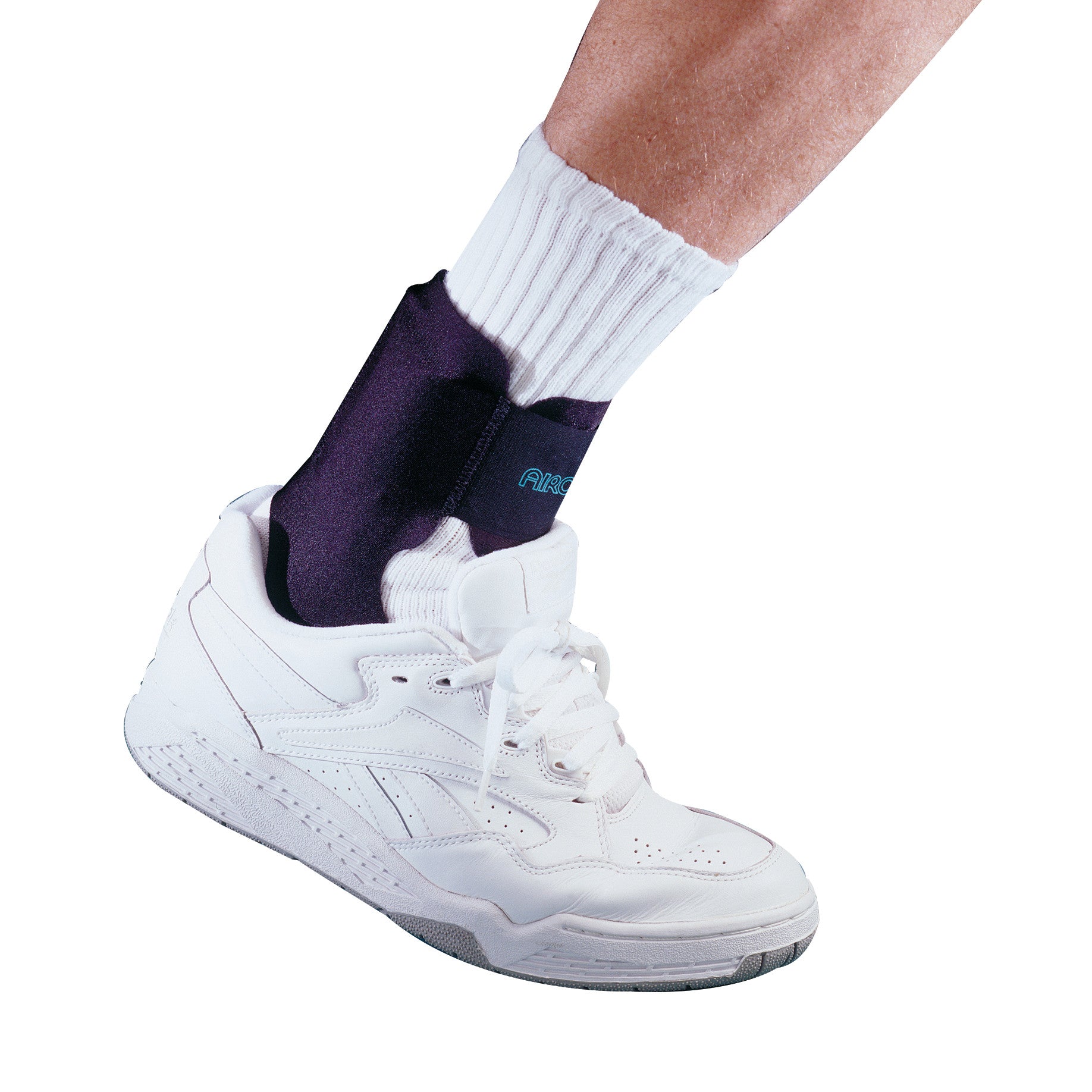 Ankle wearing an Aircast Airheel Brace over a white sock and inside a white athletic shoe, showing the brace's supportive fit.