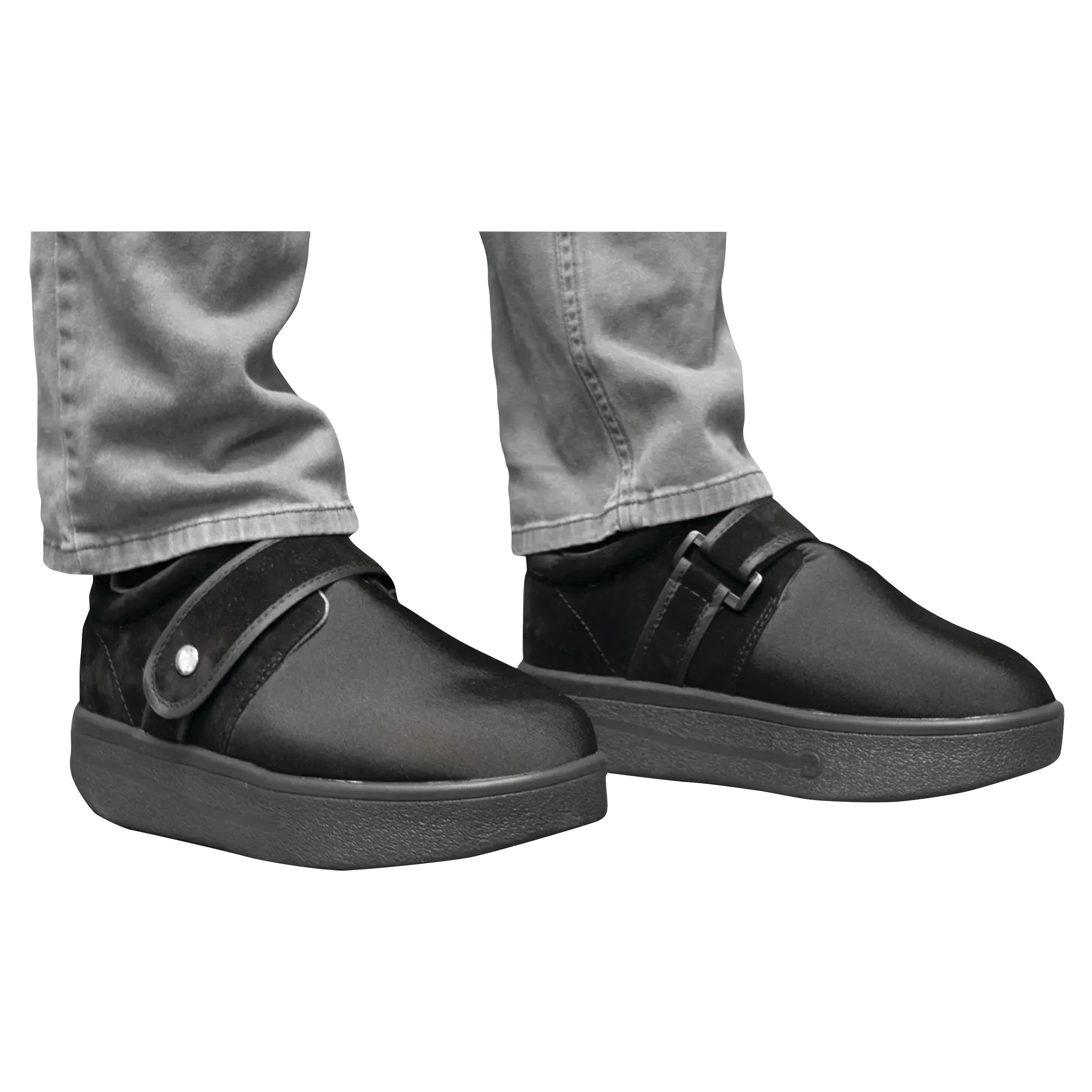 Man wearing DARCO Closed Toe Wound Care Shoe System with adjustable straps and black soles, paired with gray pants.