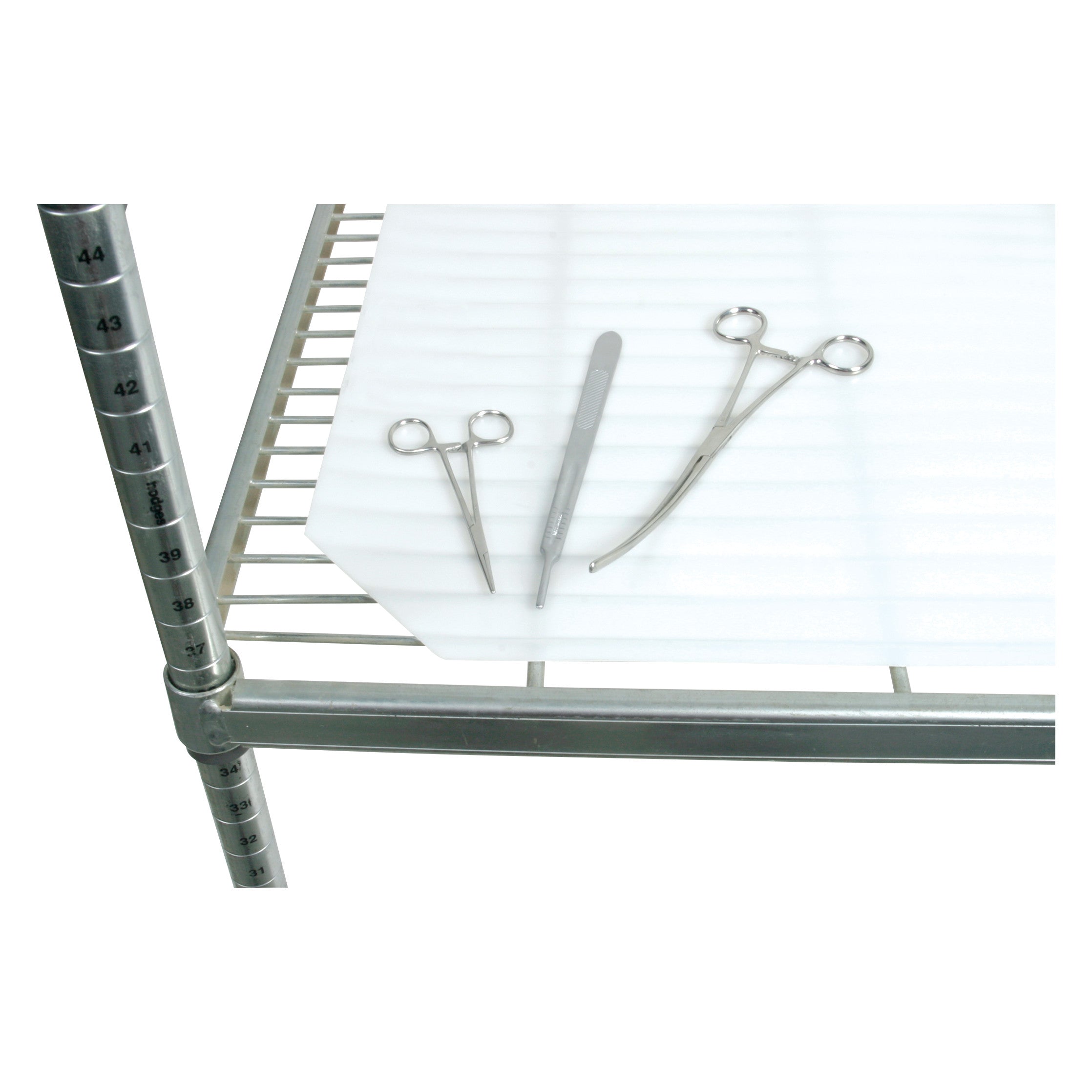 AliMed Antimicrobial Shelf Liner on a metal shelf with surgical instruments, including forceps and a scalpel, placed on top.