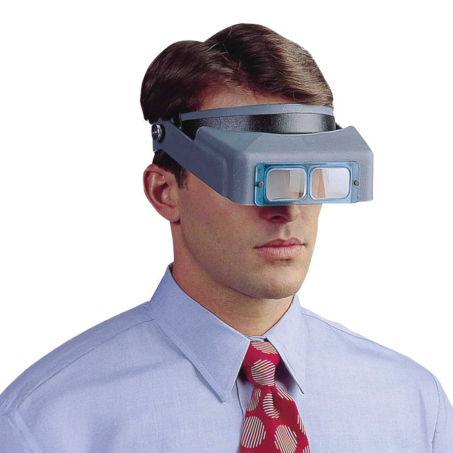 A man wears an OptiVISOR Headband Magnifier, featuring a gray headband and magnifying lenses, to enhance close-up vision.