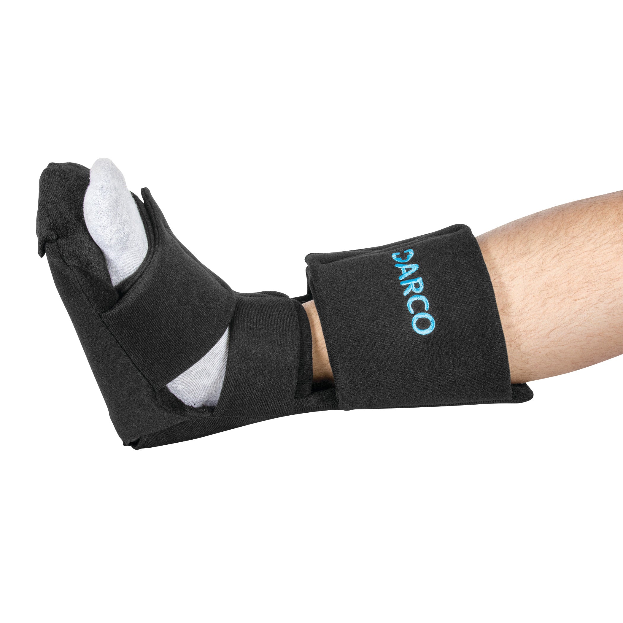 A foot wearing the DARCO Night Splint Wedge with black straps, shown positioned for support, with the brand name visible.